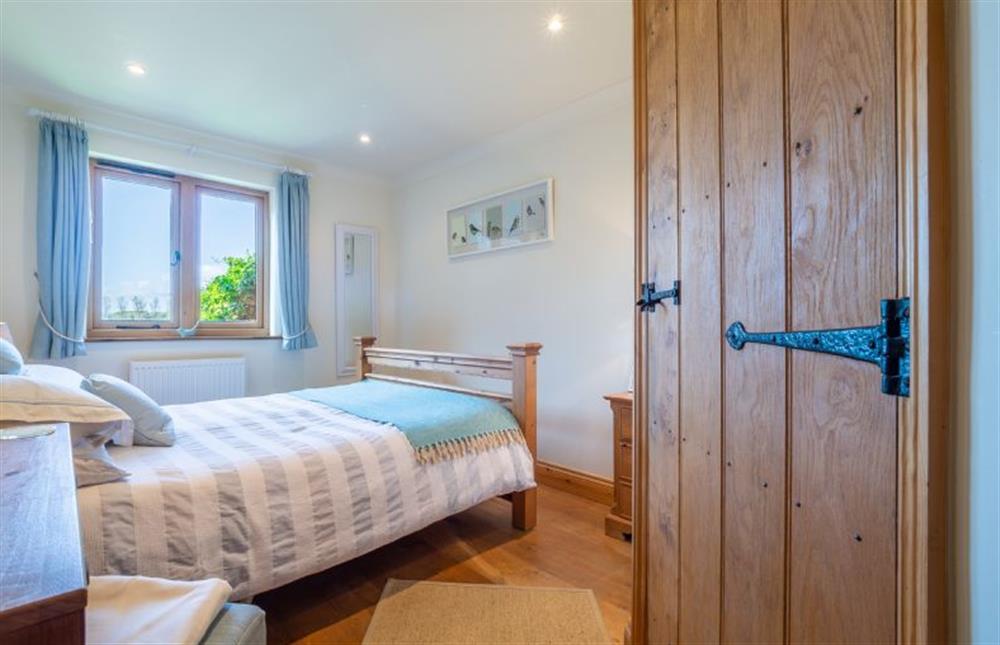 Master bedroom with king-size bed at The Meadows Dairy, Bawdsey