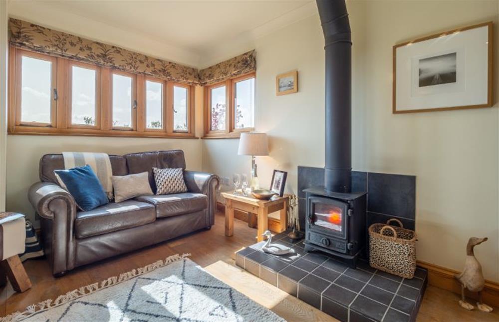 Sitting room with wood burning stove at The Meadows Dairy, Bawdsey