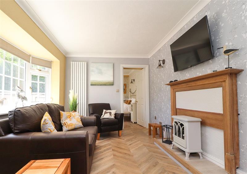 Relax in the living area at The Mews Cottage, Lytham St. Annes
