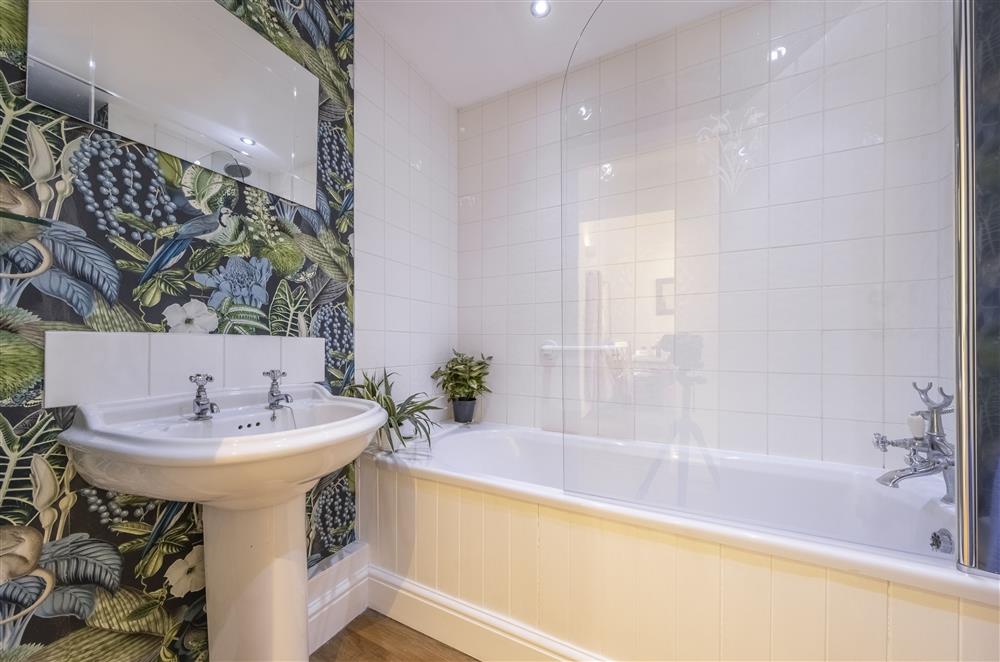 Family bathroom with a bath and overhead shower attachment at The Mews, Goudhurst