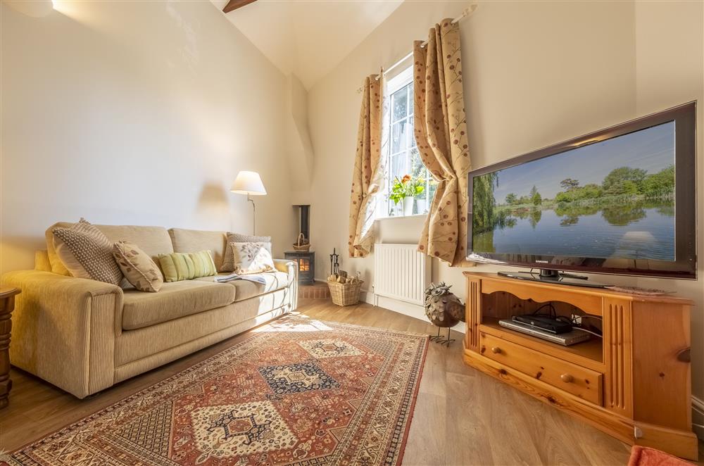 Relax by the wood burning stove in the sitting area at The Mews, Goudhurst