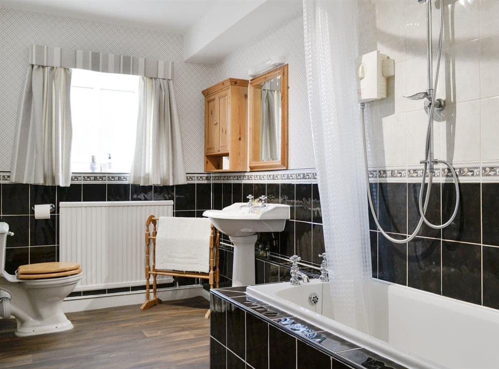 Family bathroom with shower over bath at The Mews in Near Masham, Yorkshire, North Yorkshire