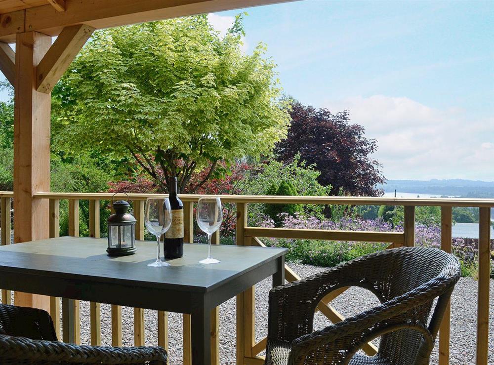 Admire the view over Loch Lomond from the terrace at The Mews in Port Of Menteith, Stirlingshire