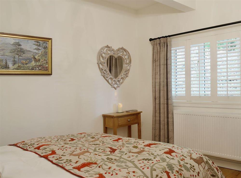 The bedroom is charming and romantic at The Mews in Port Of Menteith, Stirlingshire