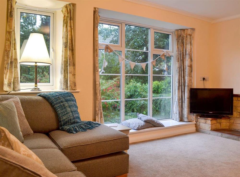 Spacious living room has wonderful views of the garden at The Mill Cottage in Heath, near Chesterfield, Derbyshire