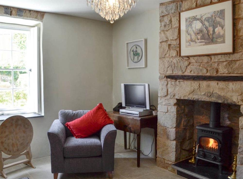 Charming living room with original fireplace at The Mill Farmhouse (Ty Fferm Y Felin) in Llandybie, near Llandeilo, Dyfed