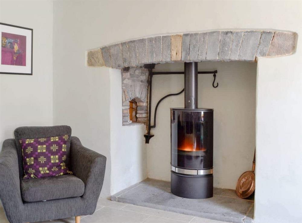 Delightful sitting room with wood burner at The Mill Farmhouse (Ty Fferm Y Felin) in Llandybie, near Llandeilo, Dyfed