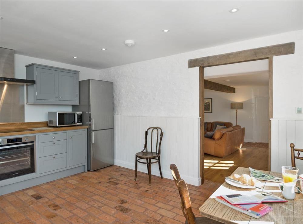 Spacious kitchen/dining room with French doors leading to garden at The Mill House in Aisholt, near Bridgwater, Somerset