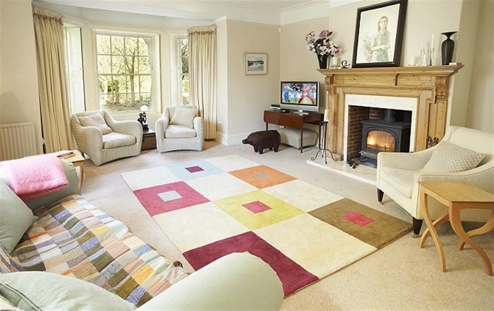 Ground floor:  Sitting room with wood burning stove at The Mill House, Buxton with Lamas