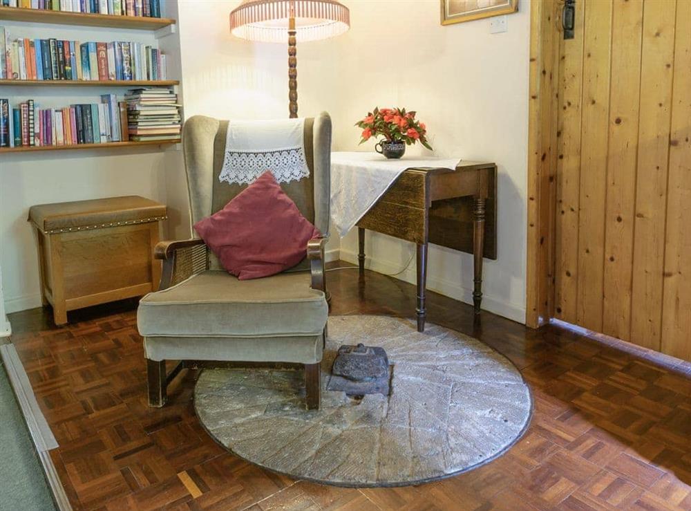 Additional lounge seating and an original millstone in floor at The Mill House in Lea, near Ross-on-Wye, Herefordshire