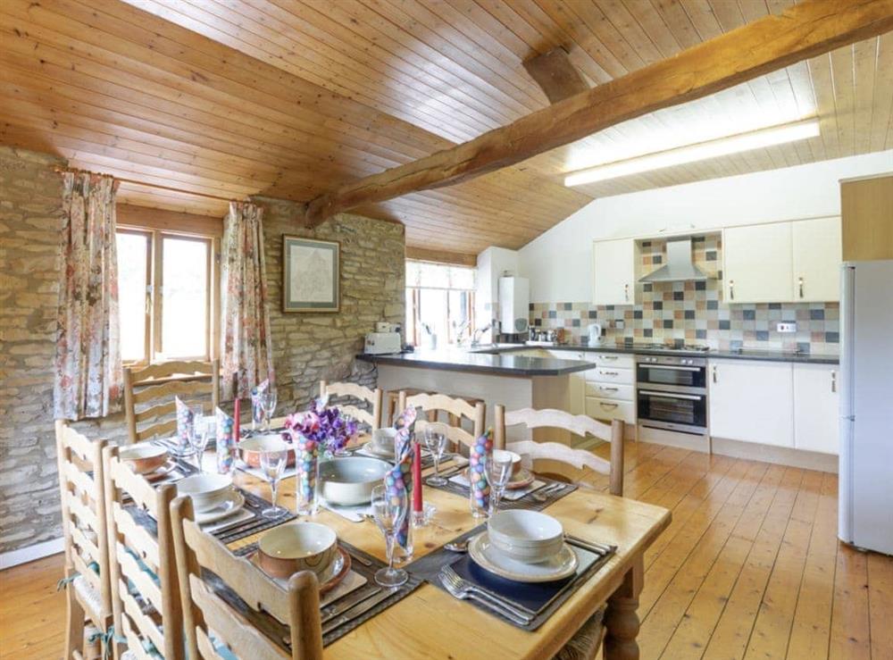 Large dining area adjoins kitchen at The Mill House in Lea, near Ross-on-Wye, Herefordshire