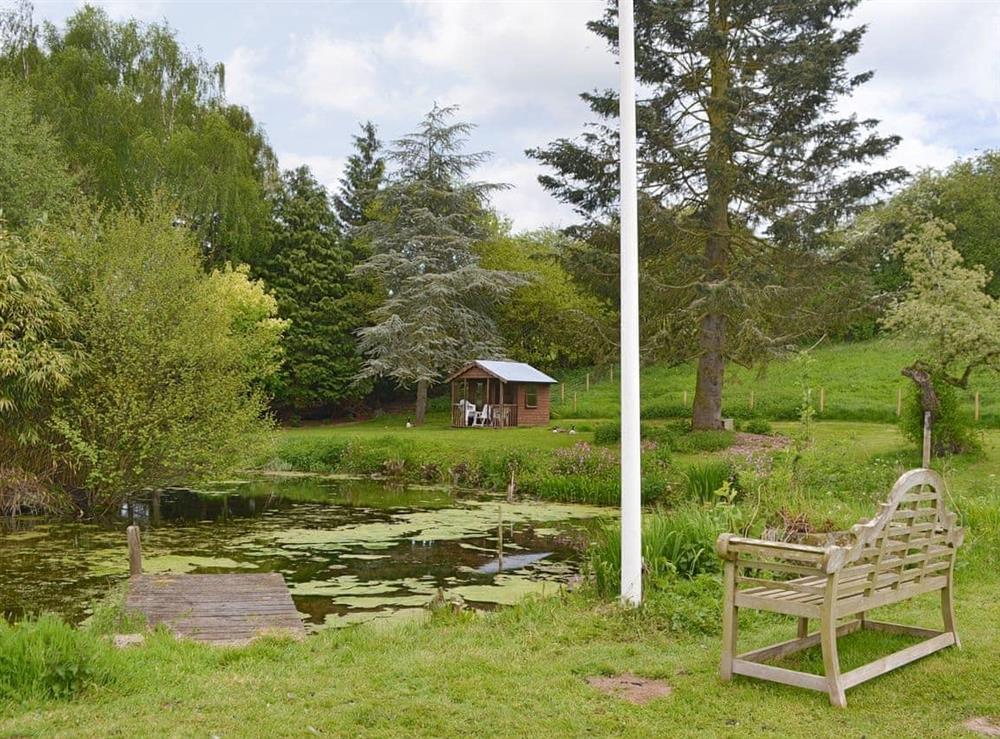 Well-maintained garden with tranquil pond at The Mill House in Lea, near Ross-on-Wye, Herefordshire