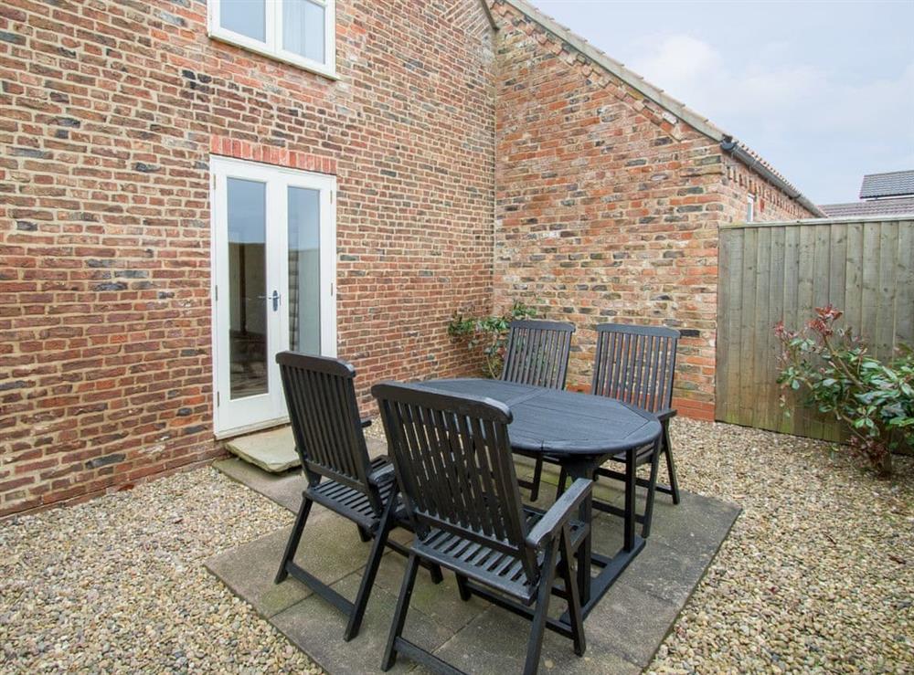Enclosed patio area with outdoor furniture at The Mill House in North Somercotes, near Louth, Lincolnshire