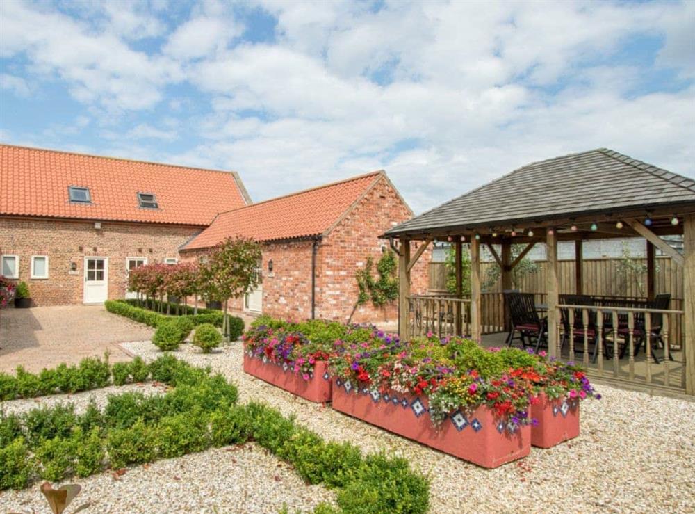 Shared courtyard with covered seating area at The Mill House in North Somercotes, near Louth, Lincolnshire