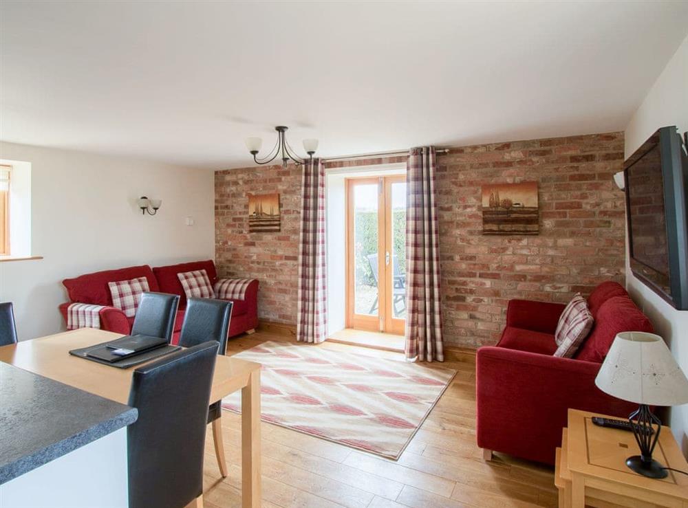 Spacious living area with French door to patio area at The Mill House in North Somercotes, near Louth, Lincolnshire