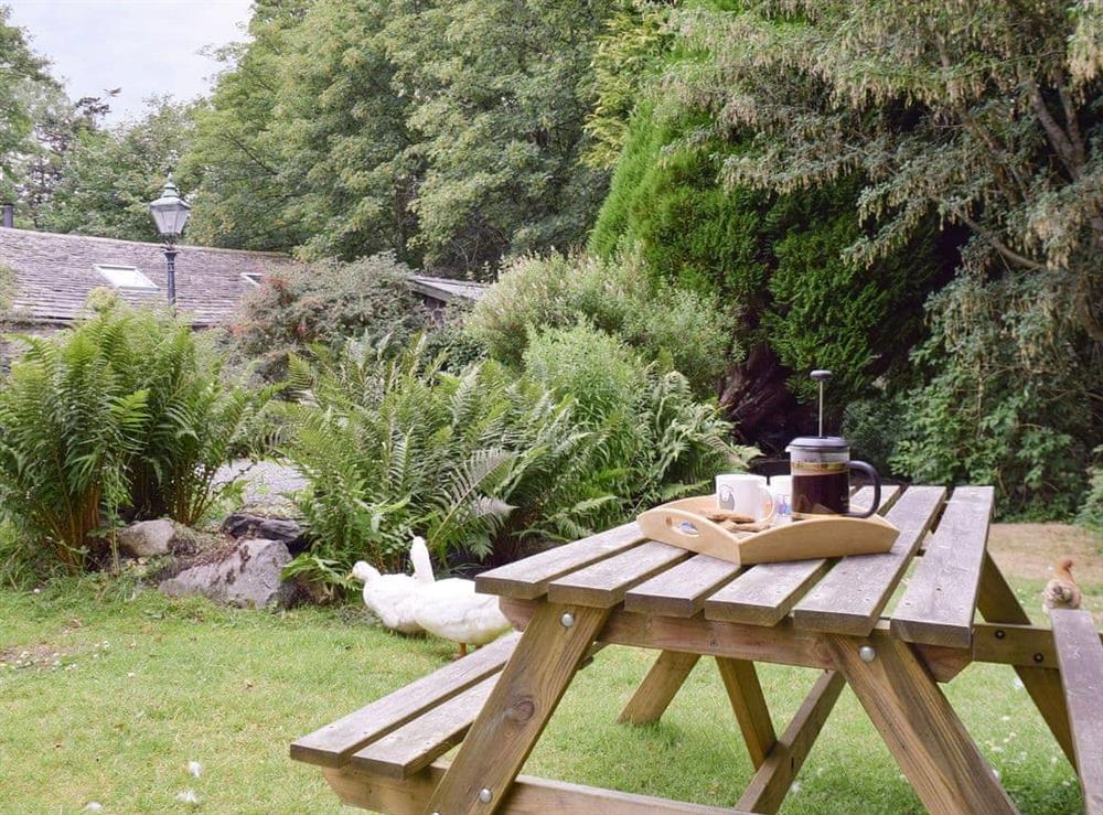 Lawned garden area with outdoor furniture at The Mill in Penrith, Cumbria
