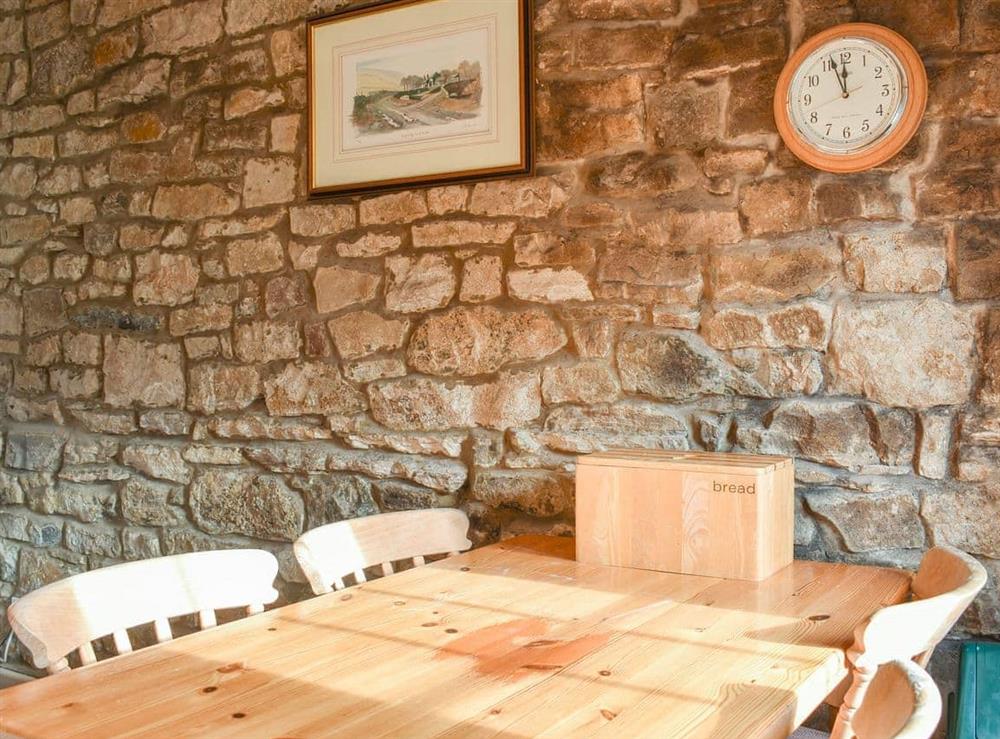 Traditional farmhouse kitchen style dining table and chairs at The Mill in West Burton, near Aysgarth, North Yorkshire