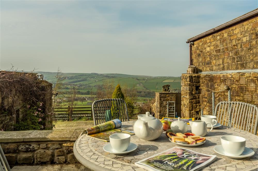 Sunny patio area with far reaching views over the Aire Valley and beyond at The Mistal, Cowling, near Keighley