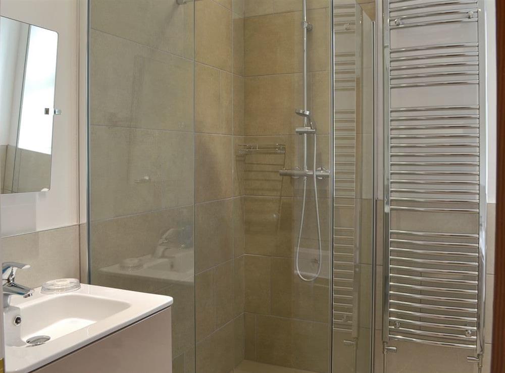 Bathroom with bath, shower cubicle and heated towel rail at The Moorings in Grange-over-Sands, Cumbria