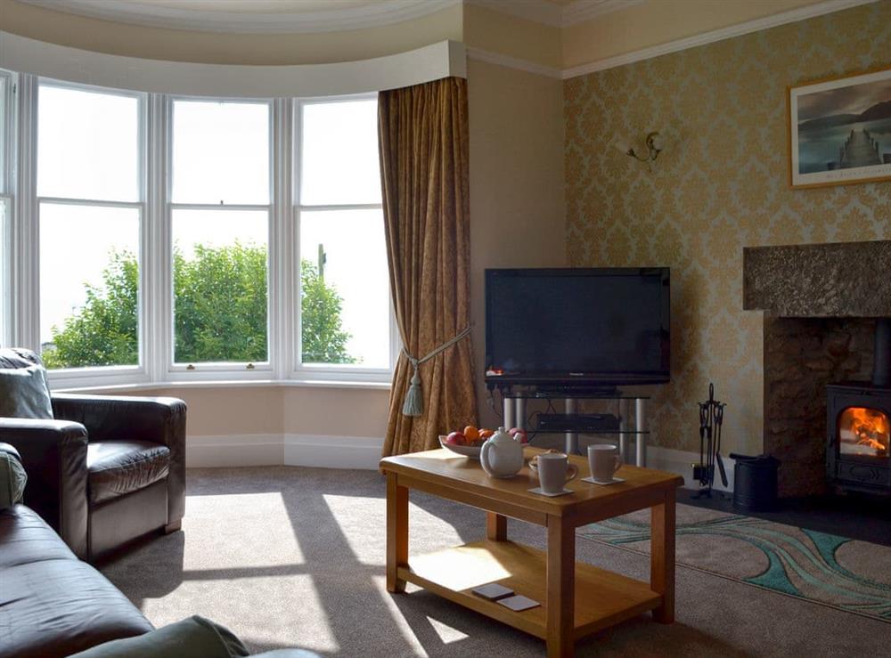 Comfortable lounge with 40” Freesat TV and wood burner at The Moorings in Grange-over-Sands, Cumbria
