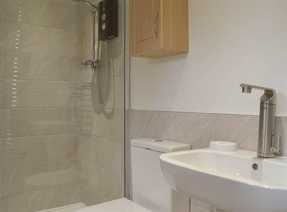 En-suite shower room with shower cubicle and heated towel rail at The Moorings in Grange-over-Sands, Cumbria