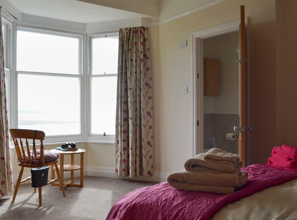 Peaceful bedroom with king-size bed and en-suite at The Moorings in Grange-over-Sands, Cumbria