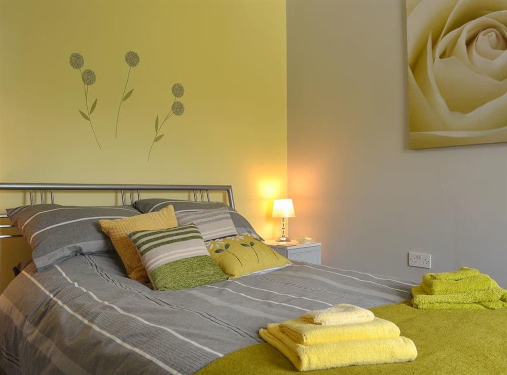 Tranquil bedroom with king-size bed at The Moorings in Grange-over-Sands, Cumbria