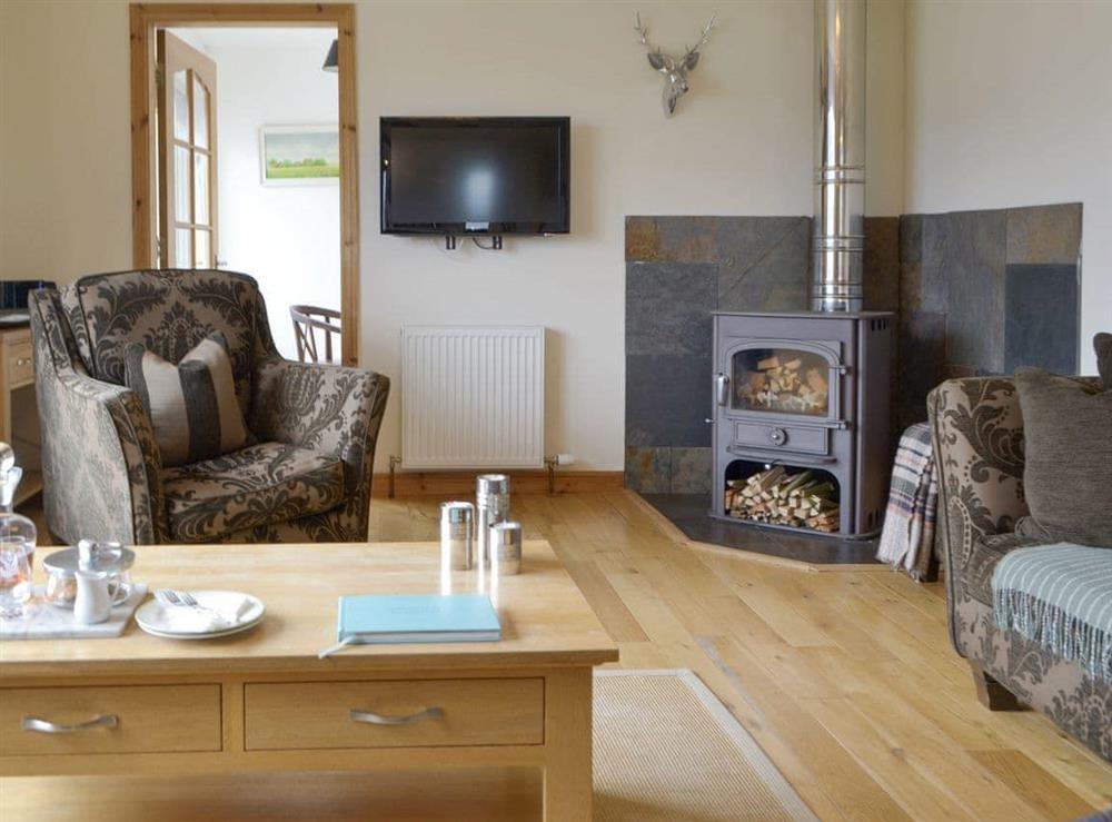 Welcoming living room with wood burner at The Narrows in Wester Alligin, by Achnasheen, Ross-Shire