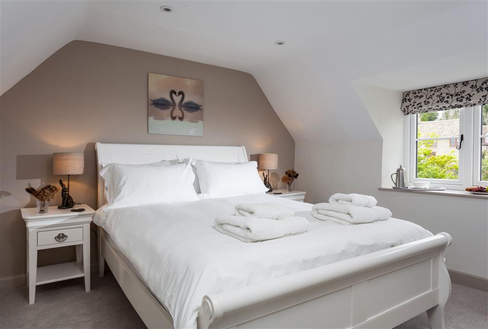 Bedroom three with a 5’ king-size bed and beautiful furnishings at The Nook, Guiting Power