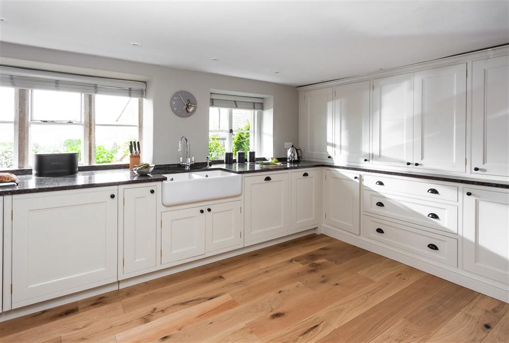 Well-equipped kitchen with an abundance of natural light at The Nook, Guiting Power