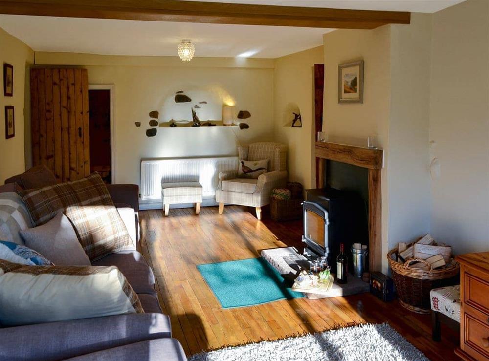 Cosy living room with wood burner (photo 3) at The Nook in Mealsgate, near Wigton, Cumbria