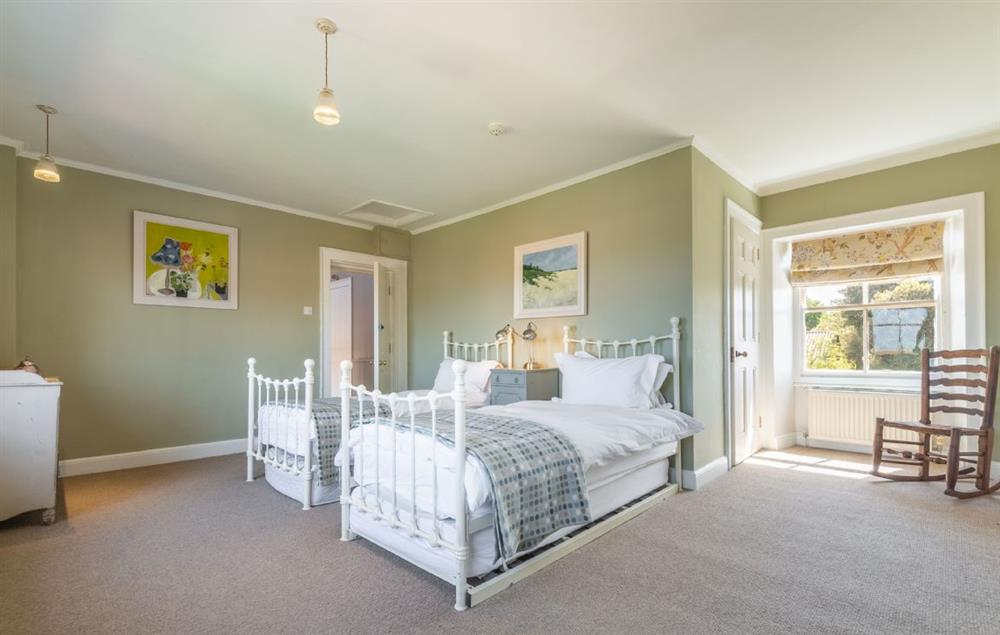 Bedroom six with twin 3’ single beds and trundle beds beneath (suitable for children) and an en-suite bathroom