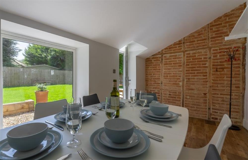 Ground floor: Dining room with feature brick wall and views into the garden at The Nurseries, Syderstone near Kings Lynn