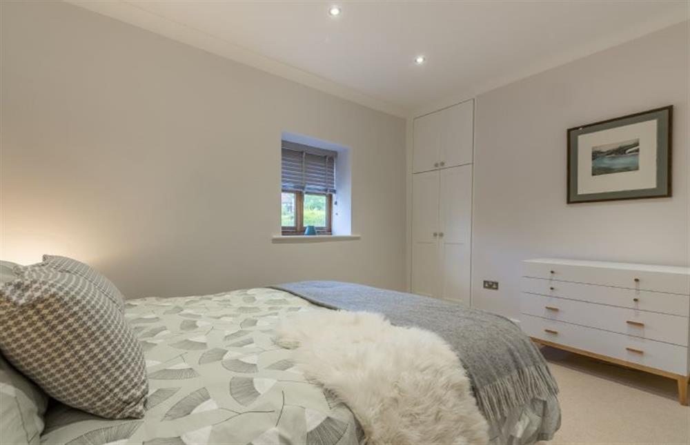 Ground floor: Master bedroom with king-size bed at The Nurseries, Syderstone near Kings Lynn