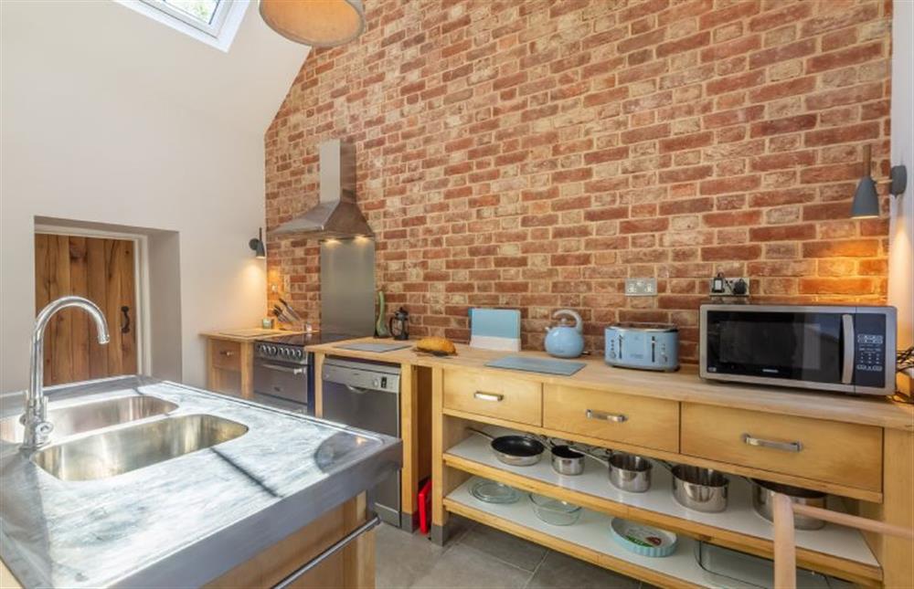 Ground floor: Modern fitted kitchen area with feature brick wall at The Nurseries, Syderstone near Kings Lynn
