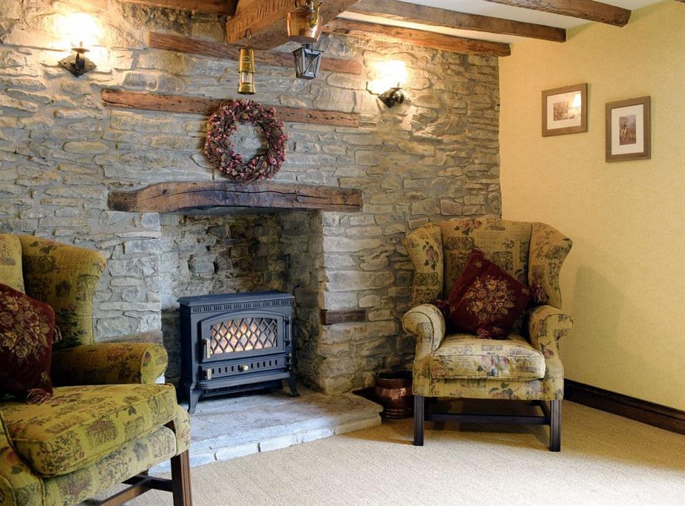 Living room with exposed stone and beamed ceiling at The Oak in Newchurch, near Hay-on-Wye, Powys