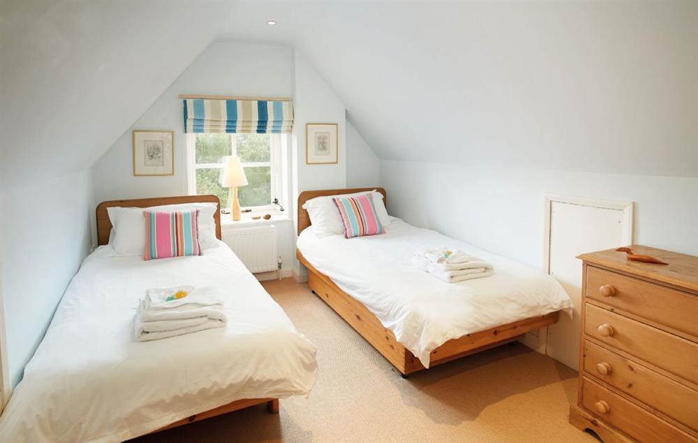 Attic bedroom with twin single beds and en-suite shower room at The Oaks, Inwood