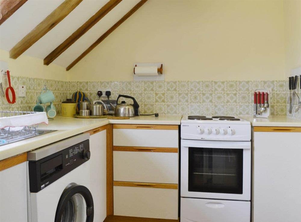 Modest kitchen with many appliances at The Oast House in Whatmore, near Tenbury Wells, Shropshire