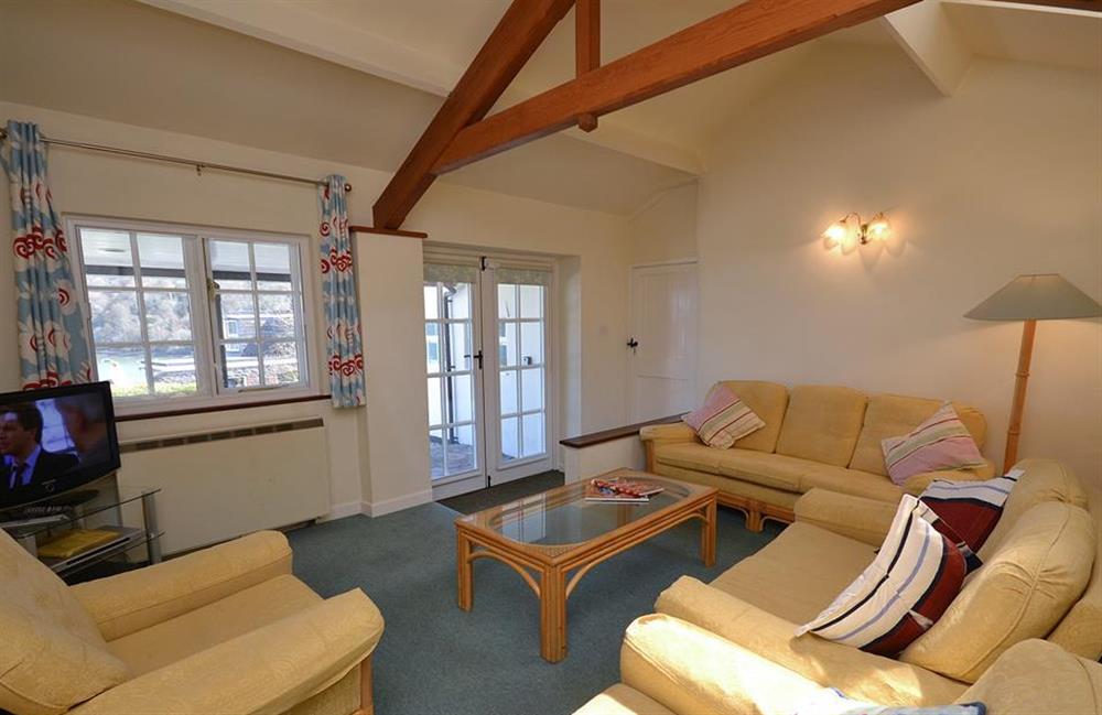 The sitting room has doors opening onto the verandah at The Old Bakehouse, Dittisham