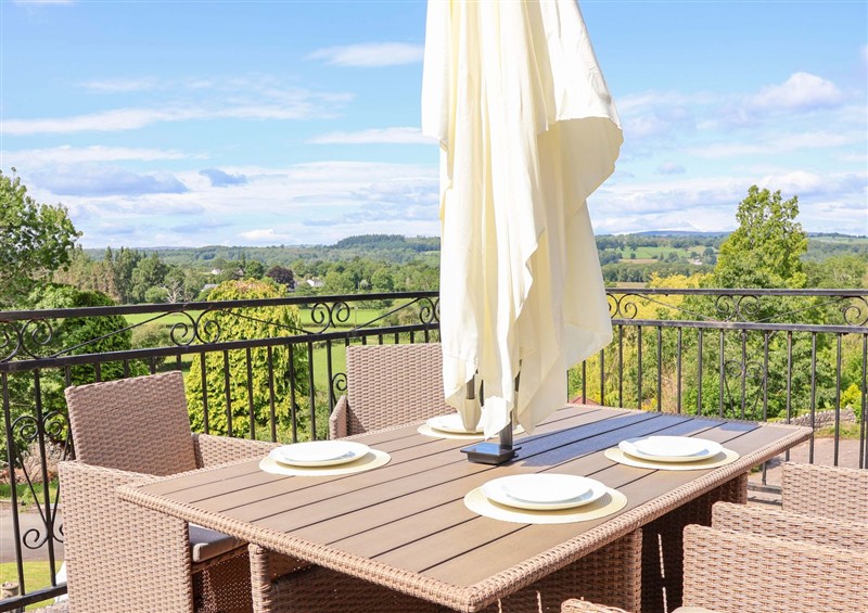 Enjoy a cup of tea on the patio at The Old Barn, Pentre Celyn