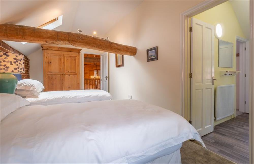 Bedroom three with exposed beams, which are low at The Old Barn, Semer