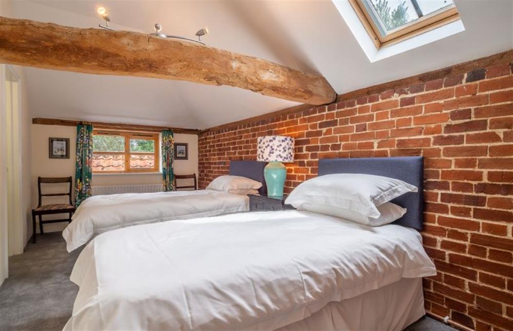 Bedroom three with twin single beds and Jack and Jill shower room access at The Old Barn, Semer
