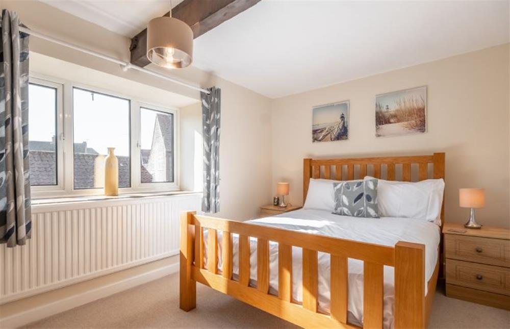 First floor: Bedroom two with a double bed at The Old Barn, Weybourne near Holt