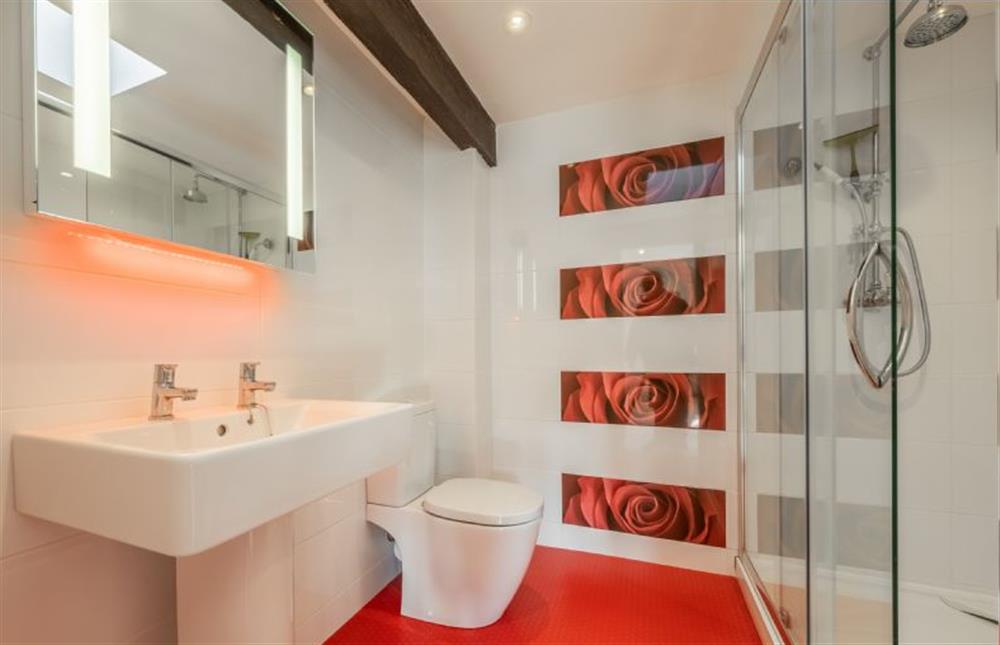 First floor: En-suite shower with wash basin and WC at The Old Barn, Weybourne near Holt