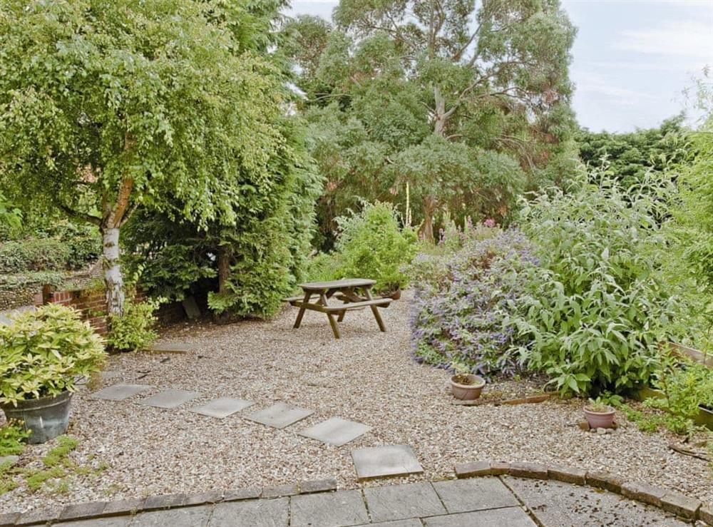 Small enclosed garden with patio at The Old Blacksmiths in Burnham Market, Norfolk., Great Britain
