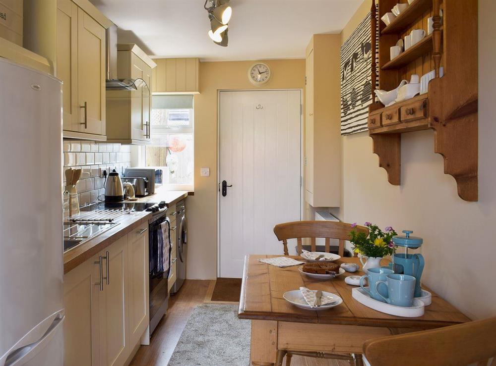 Galley style kitchen with dining area at The Old Boat Store in Totland, near Freshwater, Isle of Wight
