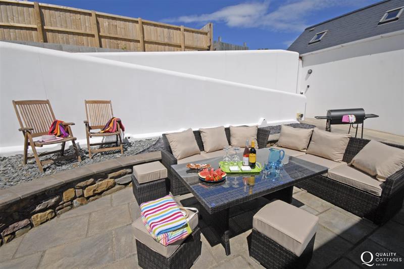 Private patio with Rattan furniture at The Old Boathouse, Trefin