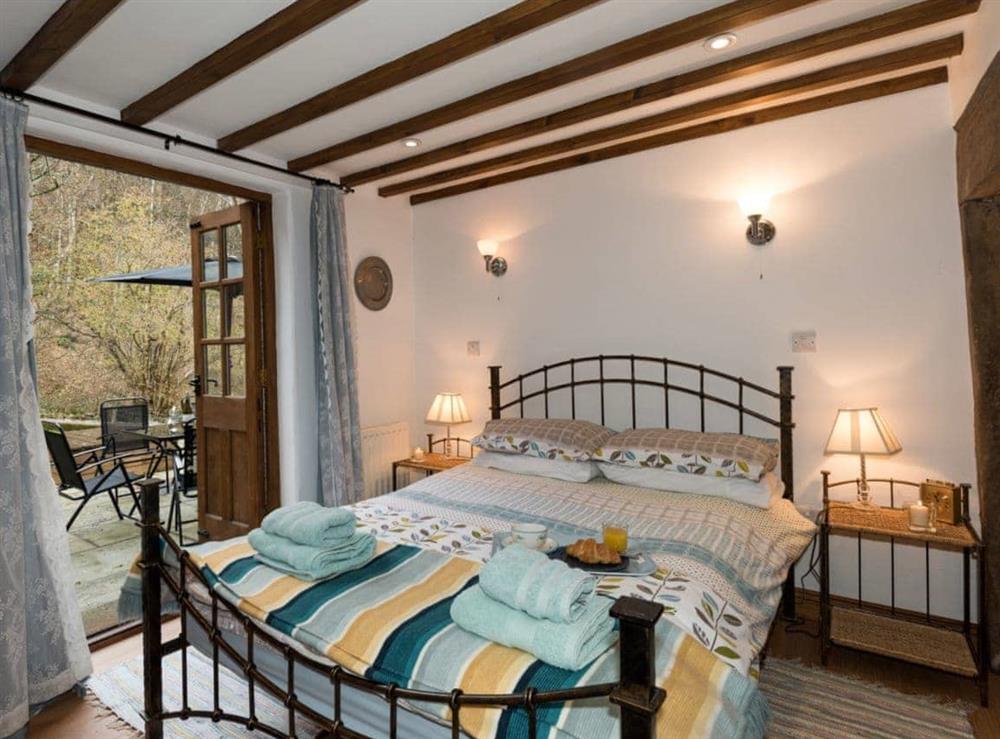 Ground floor double bedroom with patio doors at The Old Bothy in Watermillock, near Ullswater, Cumbria