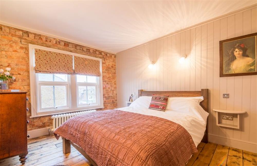 First floor: Bedroom two has king-size bed at The Old Butchers Shop, Heacham near Kings Lynn
