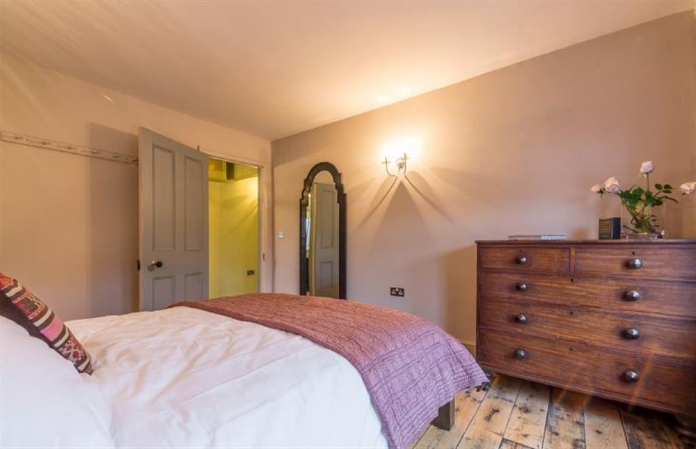 First floor: King-size bed in bedroom two at The Old Butchers Shop, Heacham near Kings Lynn